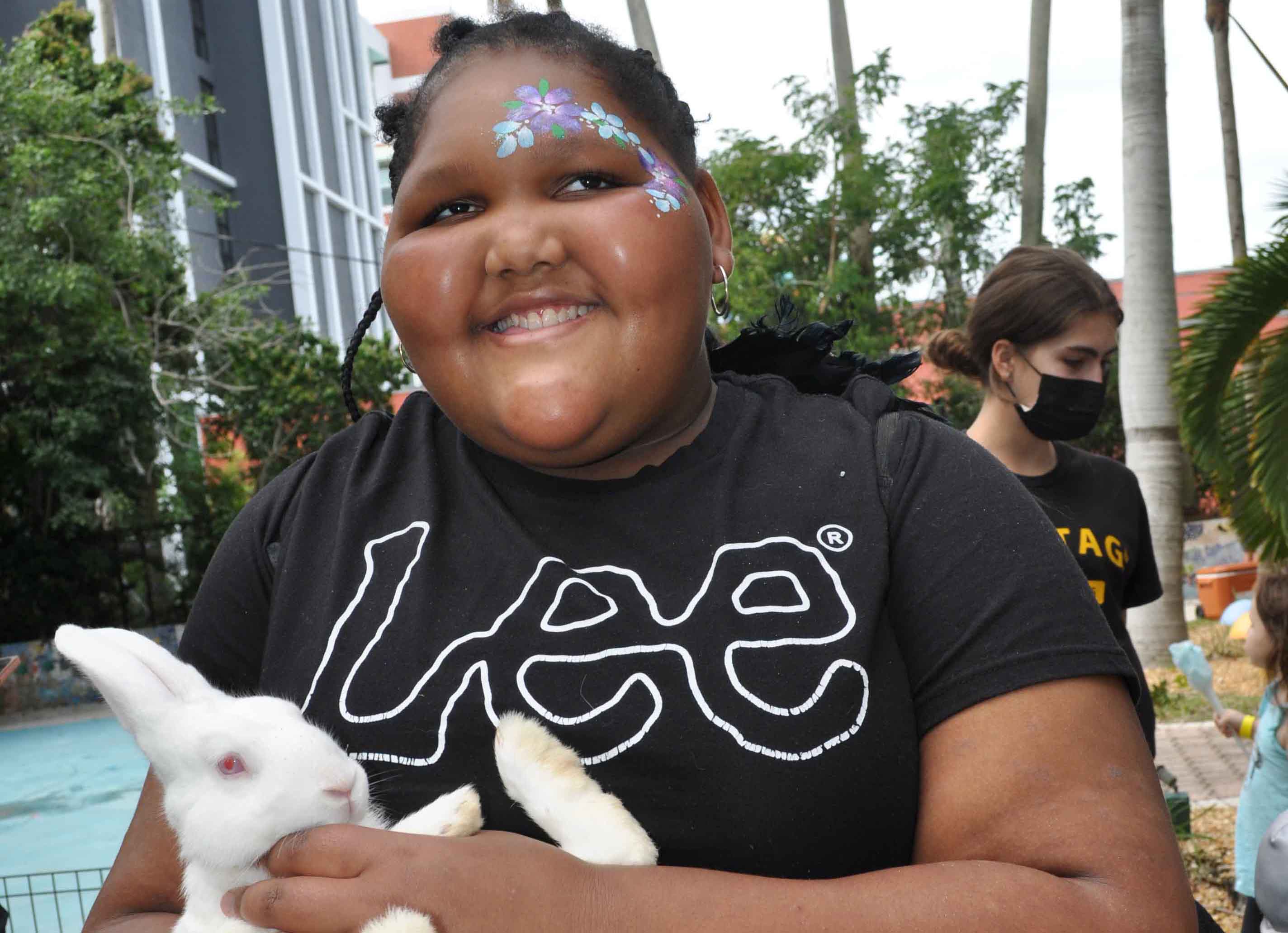 Isabelle, a client of the Lighthouse of Broward holds a bunny