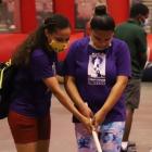 Instructor Saurym Quezada assists Alexiana Lopez